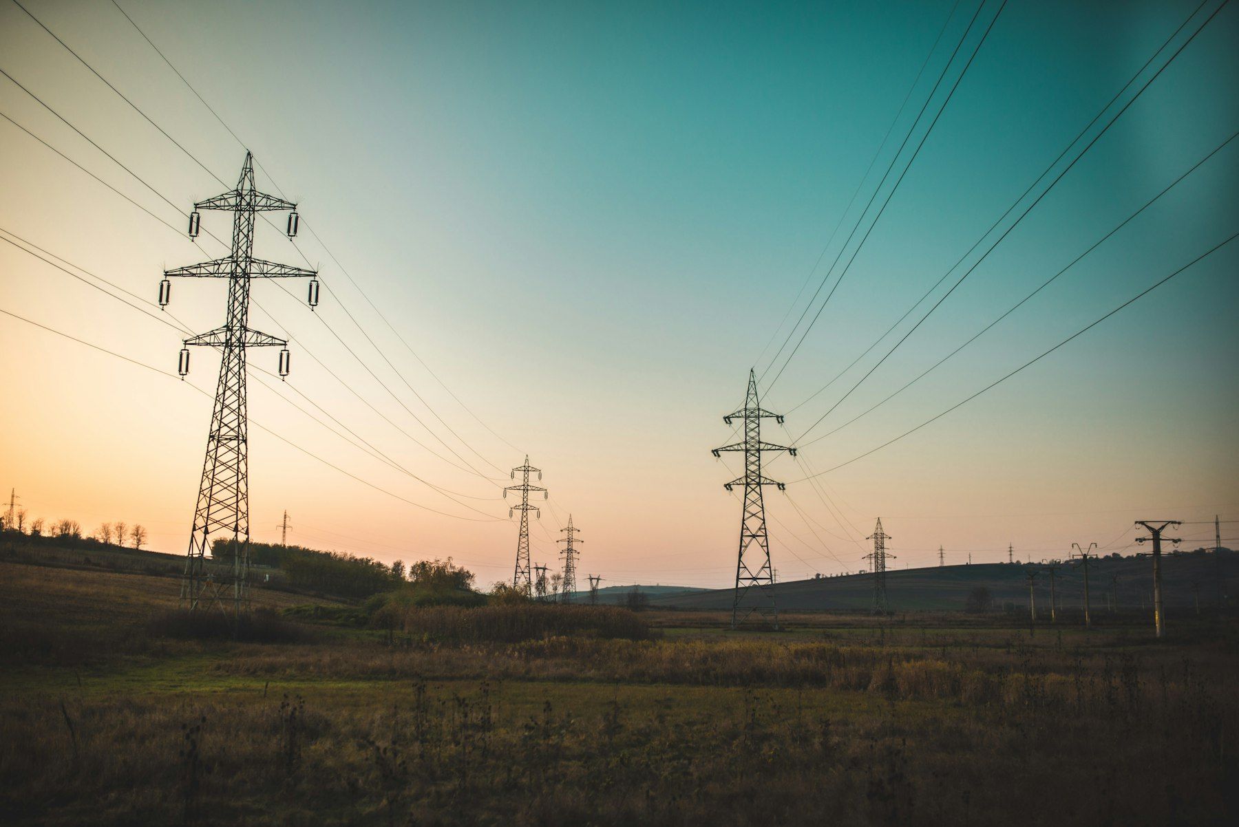 High-voltage power lines at dusk