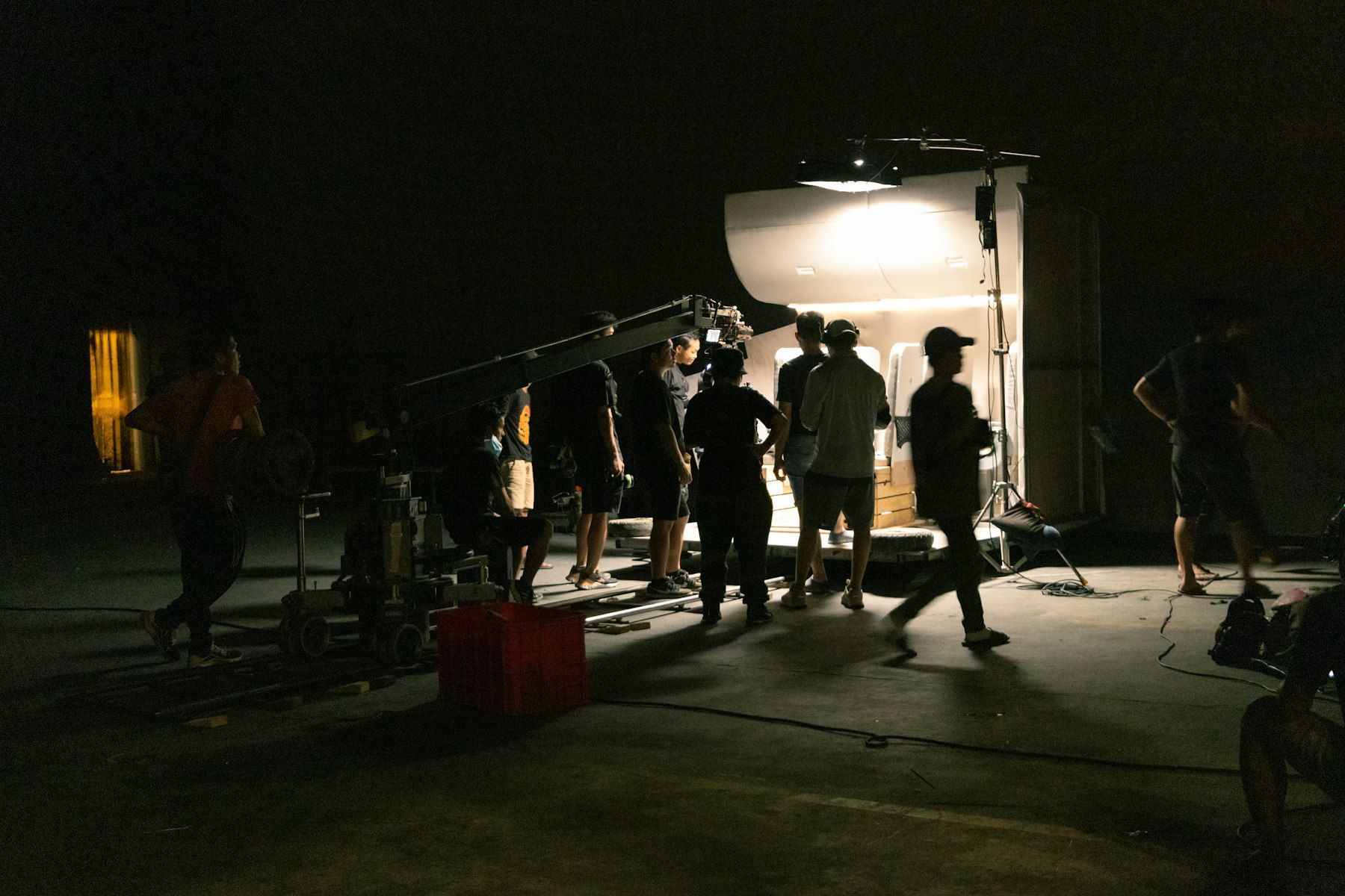 Film crew working on a set at night
