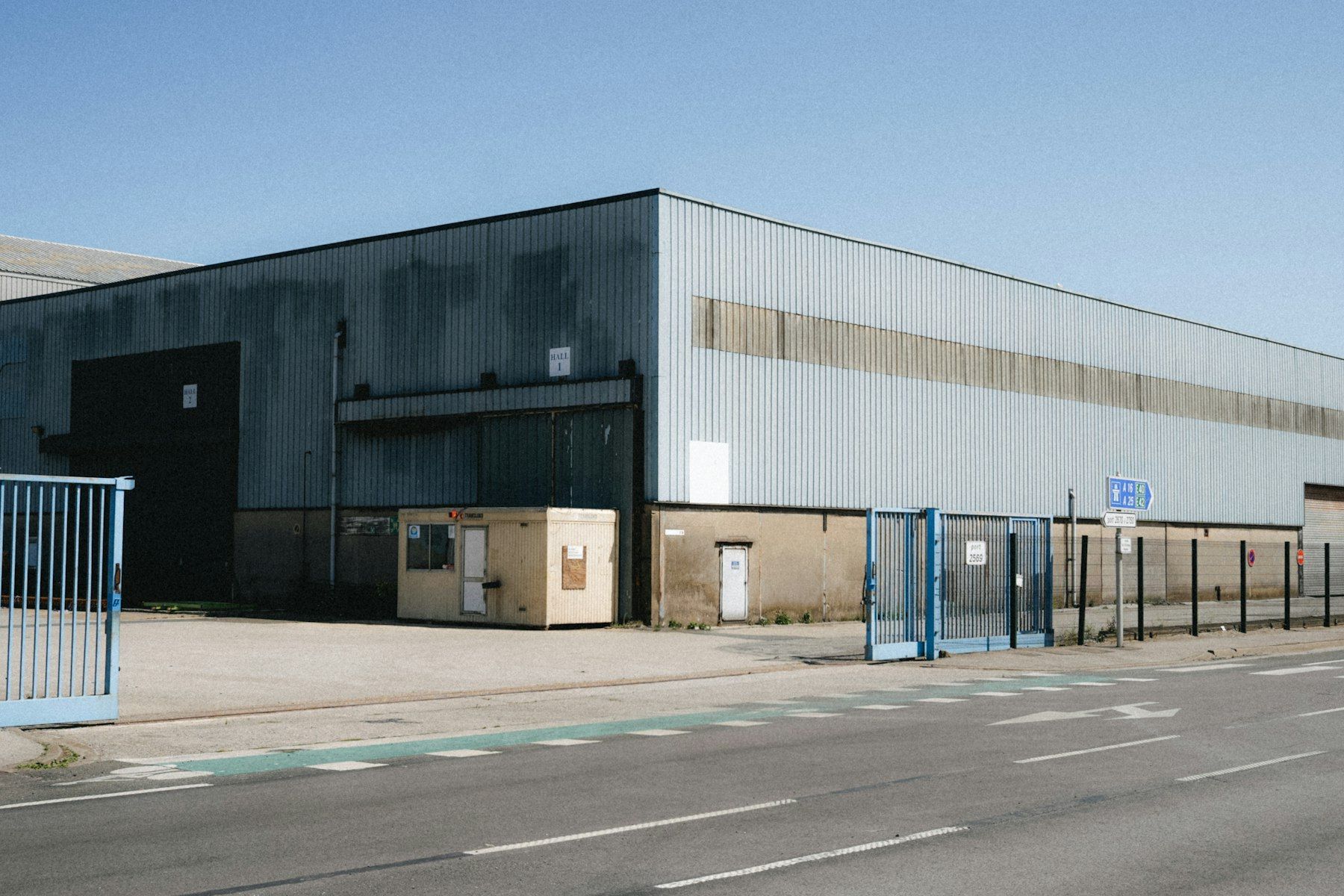 Large industrial stage building with a wide paved apron